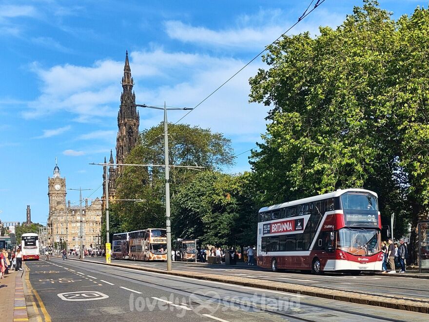 Princes Street in Edinburgh with double decker buses and the Scott Monument behind