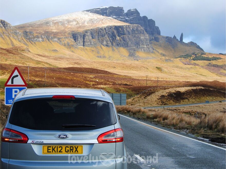 Old Man of Storr on Skye seen from the roadside with a rental car