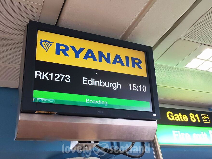 Airport gate screen showing a Ryanair flight boarding for Edinburgh