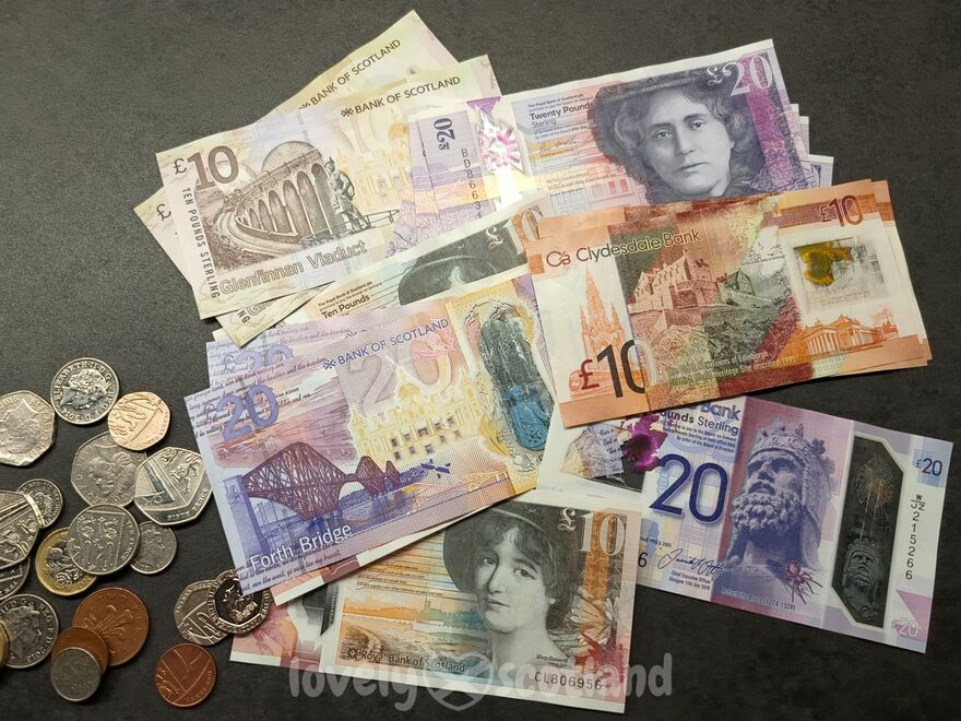 Scottish banknotes and coins spread out showing local currency used in Scotland